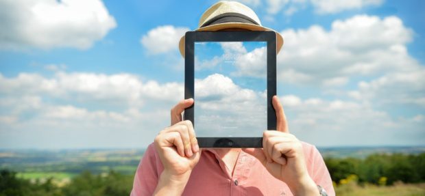 holding a tablet